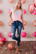 Full body image of model in Wild Fusion Leopard V-Neck Tee with party balloons backdrop