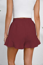 Back view of wine shorts showing soft drape and casual cut.