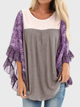 Woman wearing BlossomEase Blouse in lavender with floral sleeves and relaxed fit.