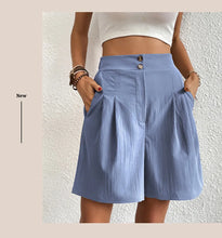 Women's light blue partial elastic high waist pleated baggy trouser shorts, front view.
