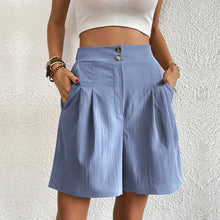 Model wearing women's light blue partial elastic high waist pleated baggy trouser shorts.