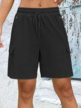 Front view of women's black quick dry drawstring loose cargo shorts.