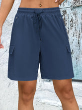 Front view of women's navy quick dry drawstring loose cargo shorts.