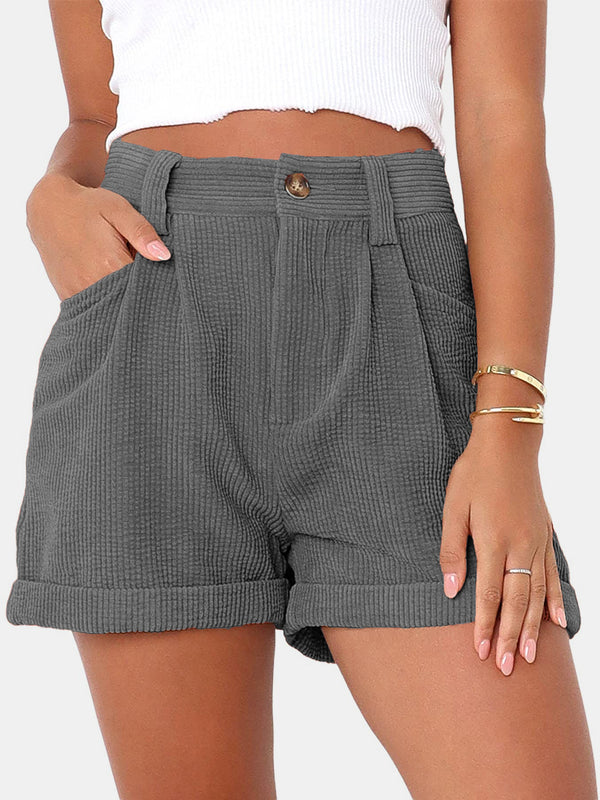 Woman modeling the dark gray Metropolitan Maven High-Waist Shorts paired with a white tank top and jewelry.