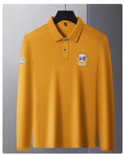 Front view of yellow Equestrian Crest Designer Polo on hanger.