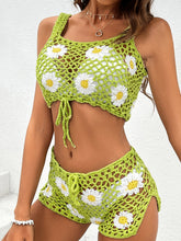 Model walking on beach in Yellow-Green Flower Cutout Two-Piece Cover Up with side slits and delicate crochet flower accents.