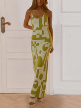 Front view of a model in Yellow-Green Luxnometry Maxi Sweater Dress posing in a grand mansion foyer with gold jewelry and nude heels.