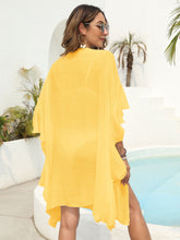 Back view of yellow ruffled open-front beach cover-up showing relaxed fit and lightweight, flowing fabric