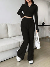 Zarisa Ribbed Zip Up Bootcut Duo black lounging at condo