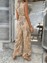Back view of tan Zauraphina jumpsuit showcasing the back button neck closure.