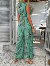 Back view of turquoise Zauraphina jumpsuit showcasing the back button neck closure.