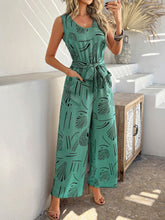 Close-up of turquoise Zauraphina jumpsuit fabric detailing the intricate print.