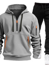 Gray Zayric StrikeFlex Set — front view featuring half-zip hoodie with contrast zippers, kangaroo pocket, arm pocket, and tapered-leg pants