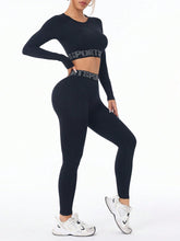 Close-up of bold letter print on black ZephyrCore MotifFit top and textured compression fabric.