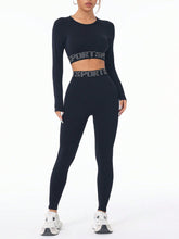 Model wearing ZephyrCore MotifFit Black Active Set, front view showing round-neck top and high-waist leggings with letter print.