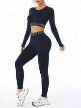 Model lounging at home in black ZephyrCore MotifFit Active Set, styled with cozy socks.