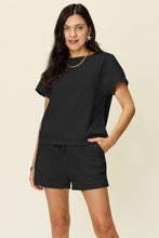Plus Size model in black Zero Lies Zone set styled with white sneakers and gold hoops for casual brunch