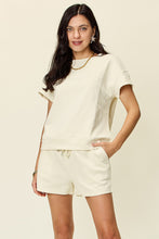 Model wearing ivory Zero Lies Zone set paired with woven sandals and a straw tote for weekend markets.
