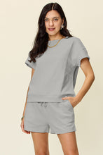 Model styled in light gray Zero Lies Zone set with casual sneakers for airport travel and lounge days.