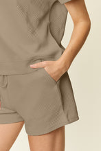 Close-up of mocha textured fabric, pocket, and waistband tie.