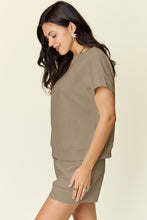 Model showcasing the side of a mocha Zero Lies Zone Texture Short Sleeve Top and Drawstring Shorts Set paired with gold jewelry and sandals.