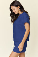 Side view of model wearing a royal blue Zero Lies Zone Texture Short Sleeve Top and Drawstring Shorts Set paired with gold jewelry.