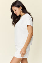 Side view of a model showcasing the Zero Lies Zone white Texture Short Sleeve Top and Drawstring Shorts Set.