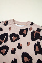 Close-up of soft Mocha leopard print fabric texture and round neckline stitching details, showcasing material quality.